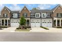 Townhome building with three units and white garages at 1135 Laurelwood Dr, Durham, NC 27705