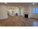 Open living space with hardwood floors, fireplace, and kitchen island at 1203 Chaney Rd, Raleigh, NC 27606
