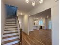 Elegant staircase with wooden railings and view into the living area at 1203 Chaney Rd, Raleigh, NC 27606