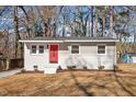 Charming single-story home with a bright red front door, tidy landscaping, and a well-maintained yard at 1404 Valley Rd, Garner, NC 27529