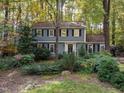 Gray house with white trim nestled in a wooded setting at 1408 Brigham Rd, Chapel Hill, NC 27517
