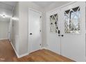 Bright entryway with hardwood floors, white doors, and coat closet at 1437 Huntly Ct, Cary, NC 27511