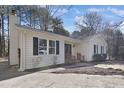 View of a white single story house with black shutters and a wooden handrail at 1437 Huntly Ct, Cary, NC 27511
