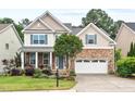 Beautiful two-story home showcasing a well-kept lawn, stone details, and an inviting front entrance at 200 Callandale Ln, Durham, NC 27703