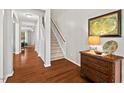 Bright foyer with hardwood floors, staircase, and elegant console table at 200 Callandale Ln, Durham, NC 27703