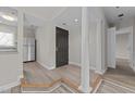 Modern entryway with hardwood floors, columns and kitchen view at 243 New Bern Pl # 301, Raleigh, NC 27601