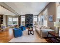 Spacious living room with a large granite fireplace, hardwood floors, and ample natural light at 255 Penley Cir, Raleigh, NC 27609