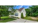 Side view of a charming home with blue shutters and landscaped walkway at 270 W Silverado Ct, Kenly, NC 27542