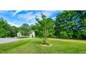 Lush front yard with mature tree and landscaped flower bed at 270 W Silverado Ct, Kenly, NC 27542