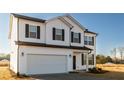 Two story house with white siding, dark brown shutters, and a two car garage at 308 Johnson Ridge Way, Four Oaks, NC 27524