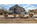 Brick home with landscaping and a fountain at 430 Federal Rd, Benson, NC 27504
