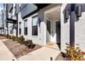 Townhome entrance with gray brick, landscaping, and a walkway at 437 Wait Ave # 100, Wake Forest, NC 27587