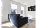 Bright living room with a sectional sofa, large windows, and hardwood floors at 437 Wait Ave # 100, Wake Forest, NC 27587