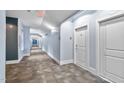 Building hallway with carpeted floor and neutral walls at 444 S Blount St # 316, Raleigh, NC 27601