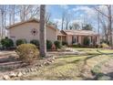 Side view of ranch home showcasing landscaping and architectural details at 5416 Fairoaks Rd, Durham, NC 27712