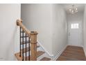 Bright entryway with hardwood floors, wooden staircase, and white door at 11 Village Edge Dr, Lillington, NC 27546