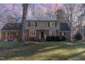 Brick home with a large yard at dusk at 11712 Black Horse Run, Raleigh, NC 27613