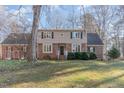 Two-story brick home with mature landscaping and a large yard at 11712 Black Horse Run, Raleigh, NC 27613