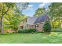 Spacious home with brick and vinyl siding surrounded by green lawn and trees at 11712 Black Horse Run, Raleigh, NC 27613