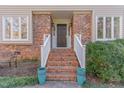 Beautiful brick entrance with stairs, white railings and blue decorative pots at 11712 Black Horse Run, Raleigh, NC 27613