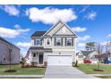 Charming two-story home with a manicured lawn, attached garage, and inviting entrance at 18 Fairwinds Drive Dr, Lillington, NC 27546
