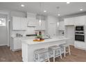 Modern kitchen featuring white cabinets, granite counters, stainless steel appliances, and a breakfast bar at 18 Fairwinds Drive Dr, Lillington, NC 27546
