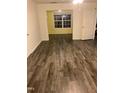 Spacious living room featuring wood-look vinyl flooring and large window at 1911 Wolftech Ln # 102, Raleigh, NC 27603