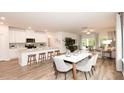 Open-concept living space with kitchen island, dining area, and adjacent living room with sliding glass doors at 2010 Cherry Creek Rd, Haw River, NC 27258