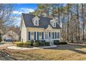 Nice yellow house with blue shutters and a spacious yard at 215 W Chestnut Ave, Wake Forest, NC 27587