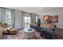 Cozy living room with L-shaped sofa and access to deck at 2251 Horton Park Dr, Apex, NC 27539