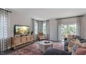 Cozy living room with large windows, comfortable seating, and a stylish rug at 2255 Horton Park Dr, Apex, NC 27539