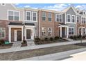 Charming brick townhomes featuring welcoming front porches and well-maintained landscaping at 277 Chesapeake Commons St # 94, Garner, NC 27529