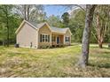 Side view of the home featuring light siding, a gray roof, and a well-maintained yard at 2857 Greenbrook Dr, Wendell, NC 27591