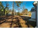 Expansive backyard surrounded by mature trees, offering privacy and a detached shed for storage at 404 Andrews Rd, Durham, NC 27705
