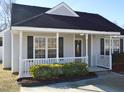 Gray house with a black roof, white porch railings, and well-manicured bushes at 5016 Parkerwood Dr, Knightdale, NC 27545
