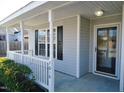 Front porch with white railings and a view of the front yard at 5016 Parkerwood Dr, Knightdale, NC 27545