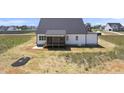 Picture of new construction farmhouse backyard with a covered back porch at 5377 River Buck Rd, Spring Hope, NC 27882