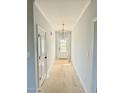 Bright entryway featuring neutral walls, chandelier, and a door with glass detailing at 5377 River Buck Rd, Spring Hope, NC 27882