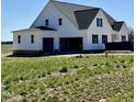 A wide view shows the large back of this new construction home with a spacious three car garage at 5377 River Buck Rd, Spring Hope, NC 27882