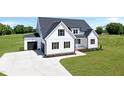 Beautiful new construction farmhouse featuring a two-car garage and concrete driveway at 5377 River Buck Rd, Spring Hope, NC 27882