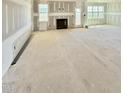 Living room features a fireplace, many windows, and an adjacent door at 5377 River Buck Rd, Spring Hope, NC 27882