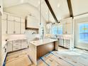 New kitchen featuring white cabinets, stainless steel appliances, and a contrasting dark center island at 5820 Shawood Dr, Raleigh, NC 27609