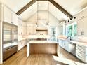 Chef's kitchen featuring white cabinetry, stainless appliances, and large island at 5820 Shawood Dr, Raleigh, NC 27609