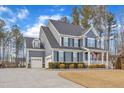 Two-story home with gray siding, white trim, and attached garage at 72 Florentino Ct, Clayton, NC 27527