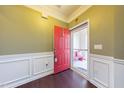 Inviting entryway with red front door and bench at 830 Downfield Ln, Fuquay Varina, NC 27526