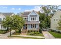 Charming two-story home with blue siding, landscaped yard, and solar panels at 1000 Norris St, Raleigh, NC 27604