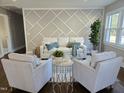 Light-filled living room features a stunning geometric wall accent and comfortable seating at 1014 E Jones St, Raleigh, NC 27601