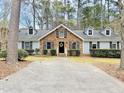 Brick and gray sided home with a large front yard and driveway at 103 Cimmaron Ct, Cary, NC 27511