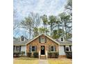 Charming brick home featuring black shutters, dormer windows, and a welcoming front door with a wreath at 103 Cimmaron Ct, Cary, NC 27511