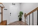 Bright entryway with wood-look floors and access to stairs at 1109 Banworth Ct, Mebane, NC 27302